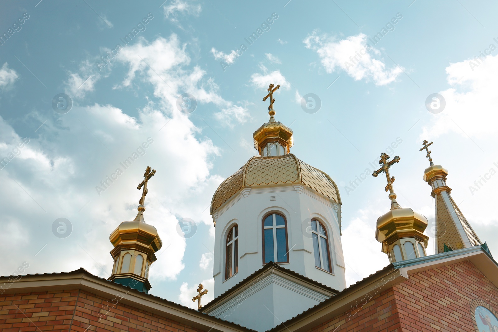 Photo of Village church against blue sky, low angle view