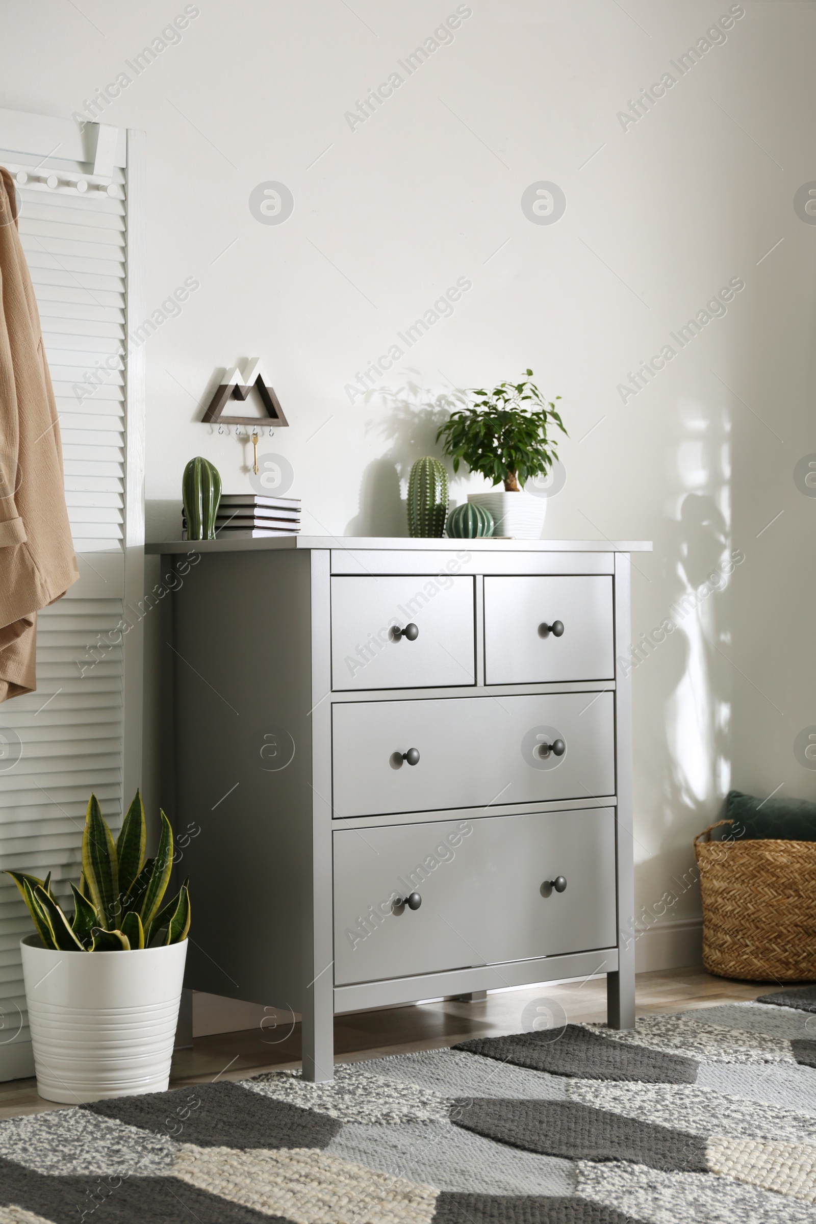 Photo of Grey chest of drawers in stylish room interior