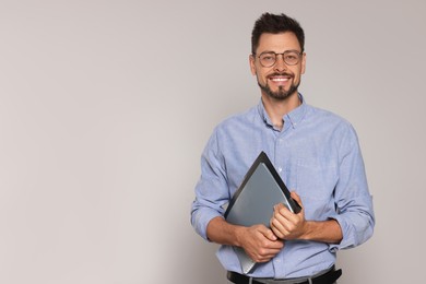 Happy teacher with glasses and stationery against beige background. Space for text