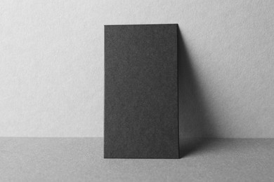 Blank black business card on grey background. Mockup for design