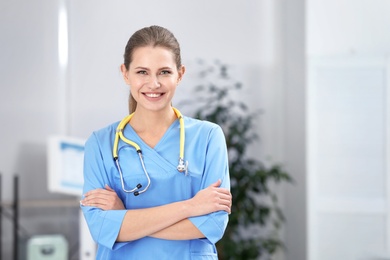 Portrait of young medical assistant with stethoscope in hospital. Space for text