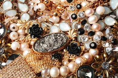 Photo of Different elegant jewelry as background, top view