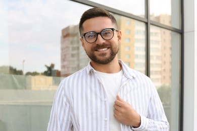 Photo of Portrait of handsome bearded man in glasses outdoors