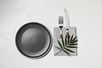 Photo of Stylish setting with elegant cutlery on white table, top view