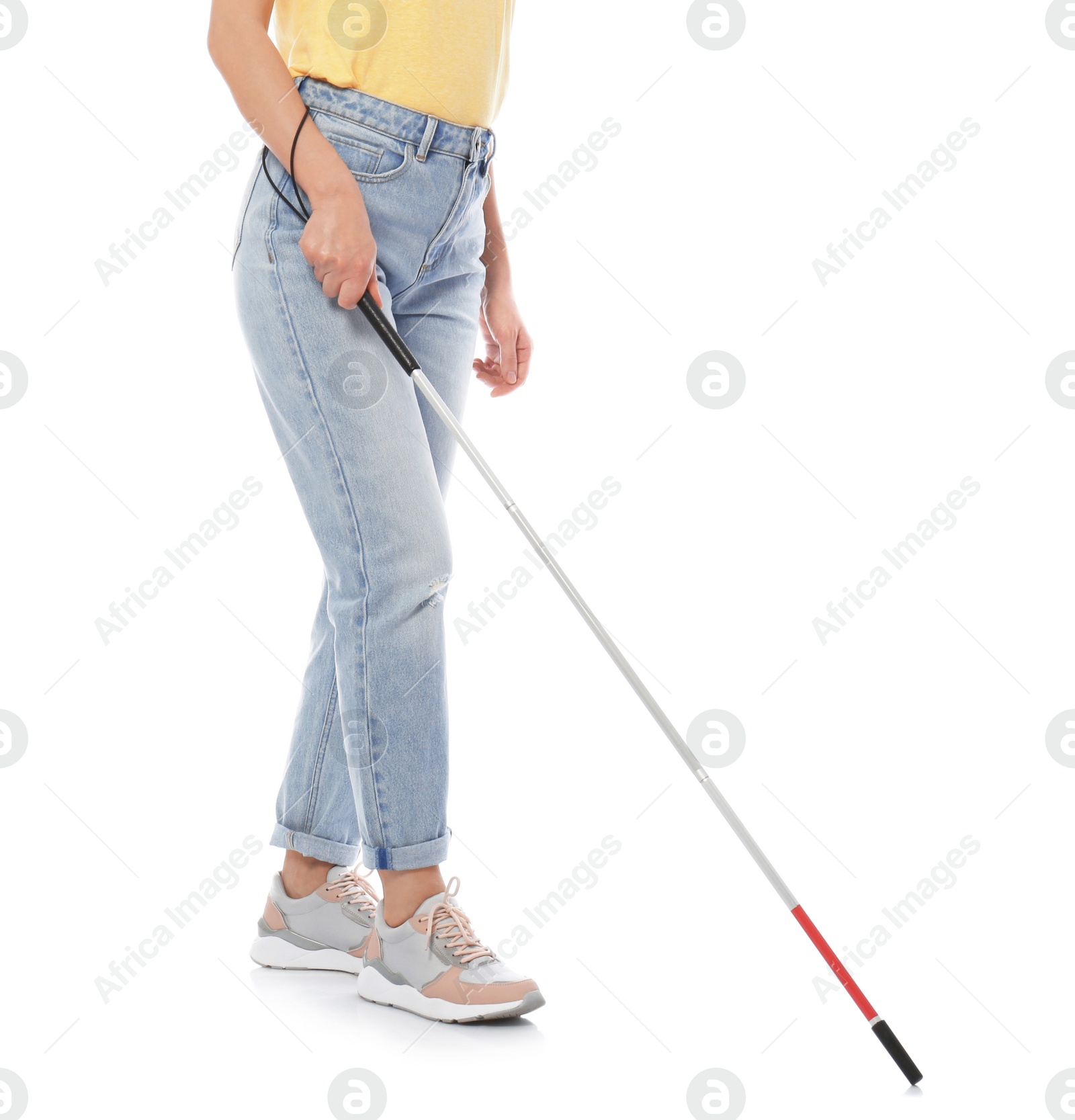 Photo of Blind person with long cane walking on white background