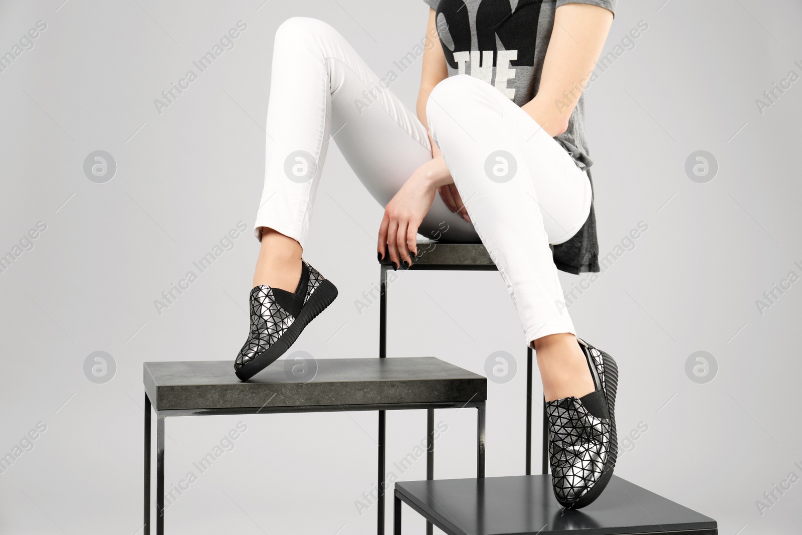 Photo of Woman in stylish shoes with stands on grey background, closeup