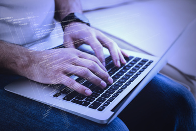 Image of Hacker working with laptop indoors, closeup. Cyber attack