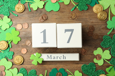 Flat lay composition with block calendar on wooden background. St. Patrick's Day celebration