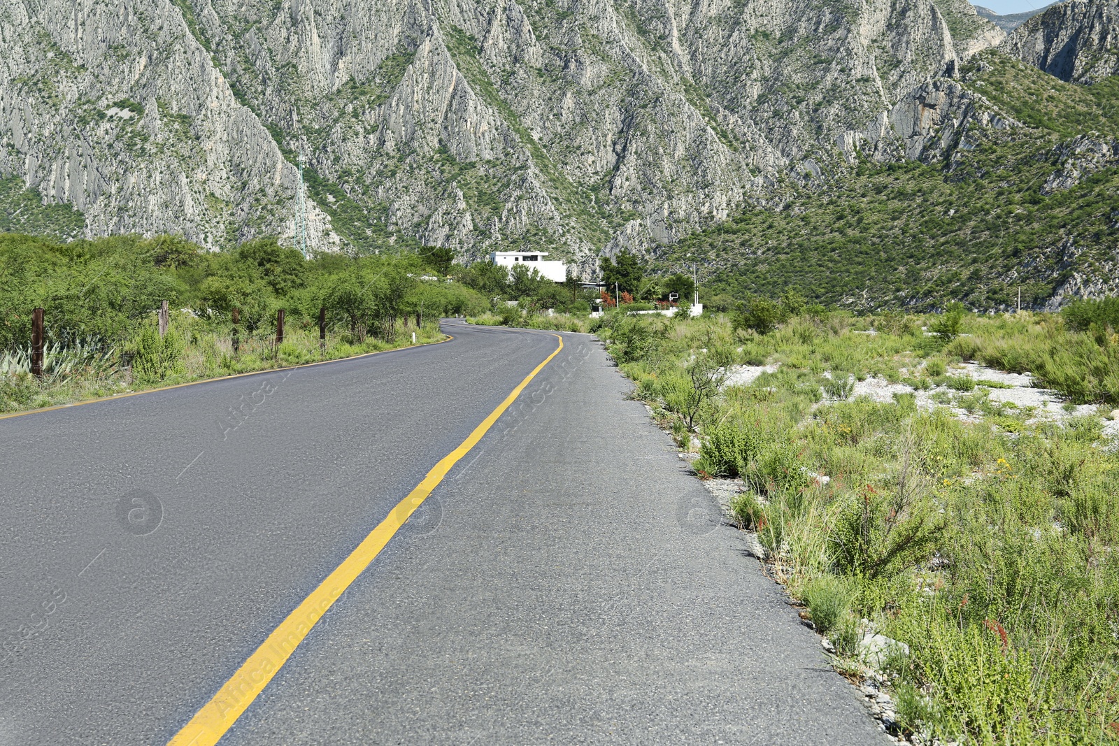 Photo of Beautiful view of empty asphalt highway near mountains outdoors. Road trip