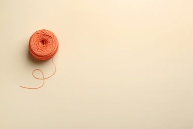 Photo of Clew of knitting threads on color background, top view with space for text. Sewing stuff