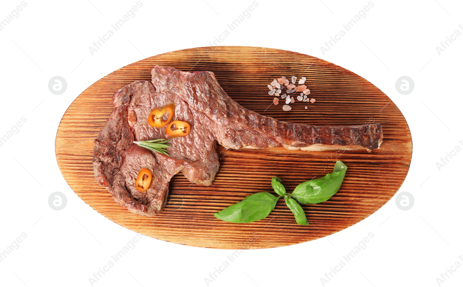 Photo of Wooden board with delicious fried beef meat, chili pepper and basil isolated on white, top view