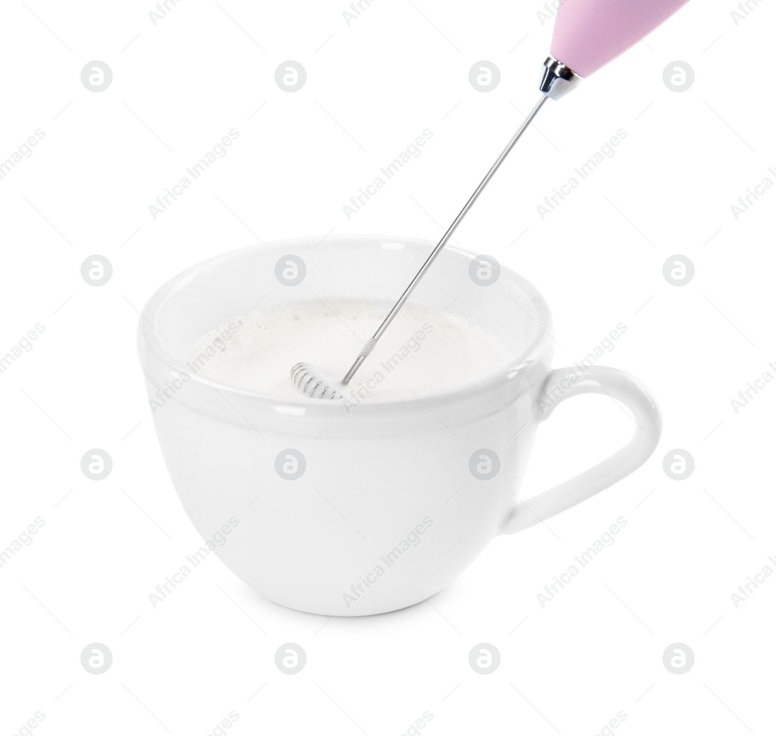 Photo of Whisking milk in cup with mini mixer (frother wand) isolated on white