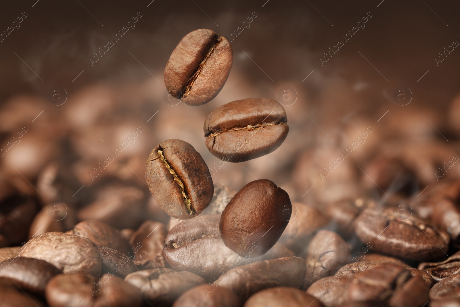 Image of Aromatic roasted coffee beans and steam, closeup