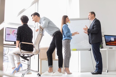 Photo of Young people having business training in office