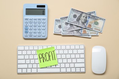 Photo of Sticky note with word Profit, keyboard, banknotes and calculator on beige background, flat lay