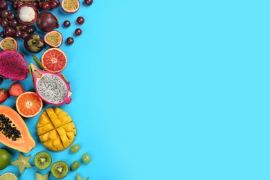 Photo of Many different delicious exotic fruits on light blue background, flat lay. Space for text