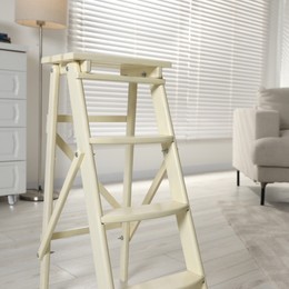 Folding ladder on wooden floor at home