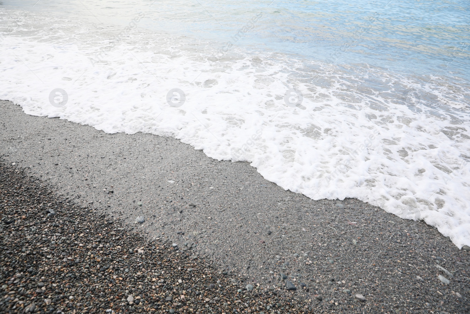 Photo of Picturesque view of beautiful sea wave on pebble beach