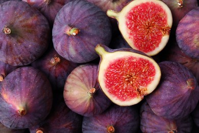 Photo of Cut and whole fresh ripe figs as background, top view