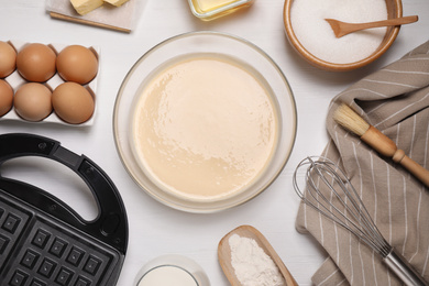 Flat lay composition with ingredients for cooking Belgian waffles on white wooden table