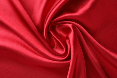 Photo of Texture of beautiful red silk fabric as background, closeup