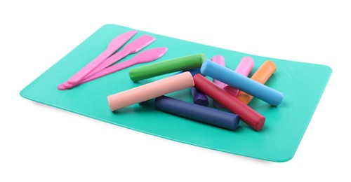 Photo of Many different colorful plasticine pieces and sculpting tools on white background