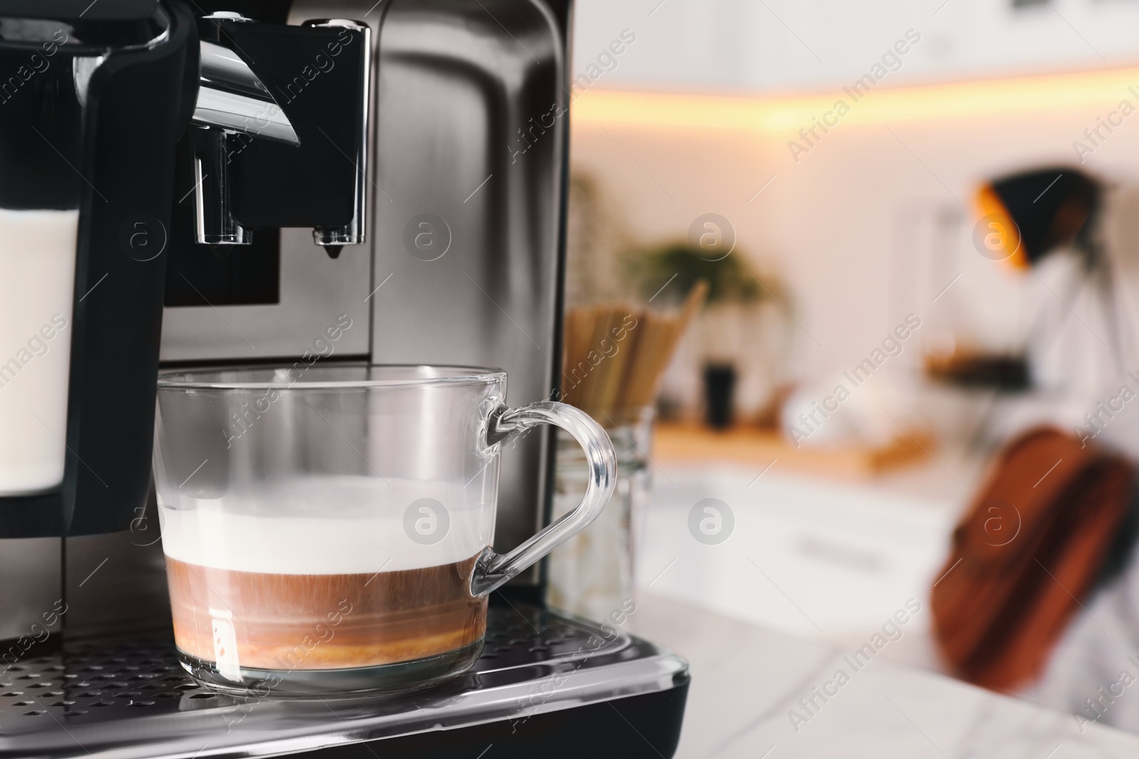 Photo of Modern coffee machine with cup of tasty drink in kitchen, space for text