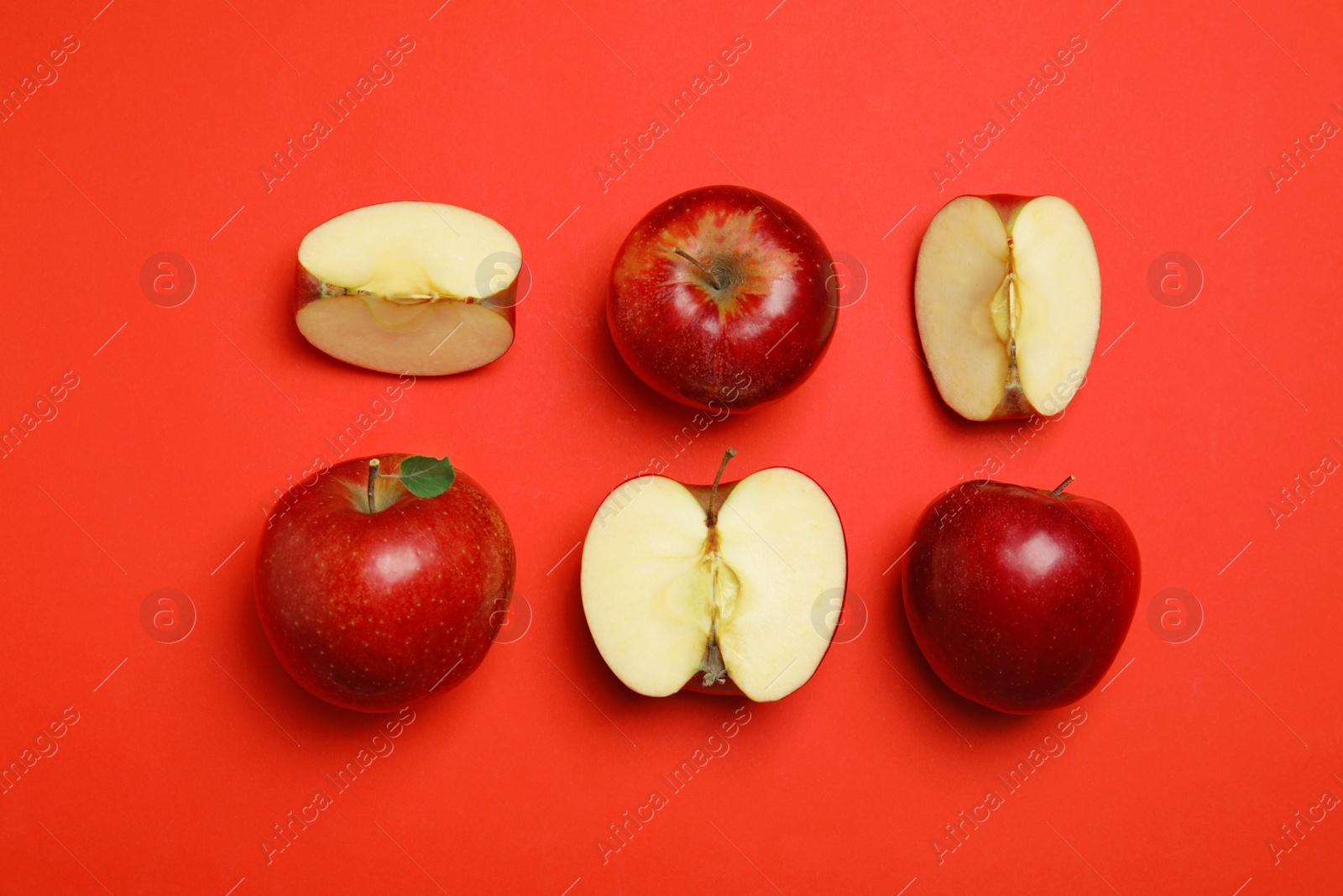 Photo of Flat lay composition with ripe juicy apples on red background