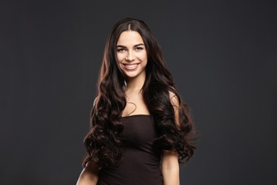 Photo of Portrait of beautiful model with gorgeous curly hair on black background