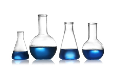 Group of chemistry glassware with liquid samples isolated on white