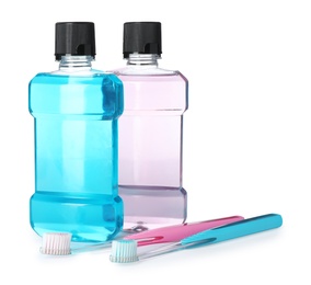 Mouthwash and other items for teeth care on white background