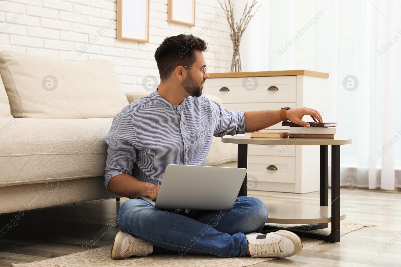 Photo of Man using laptop for online shopping at home