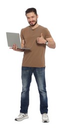 Happy man with laptop showing thumbs up on white background