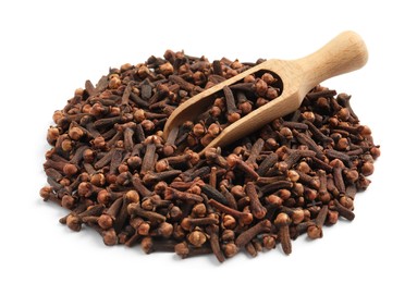 Pile of aromatic dry cloves and wooden scoop on white background