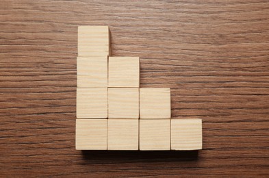 Photo of Blank cubes on wooden table, flat lay with space for text. Idea concept