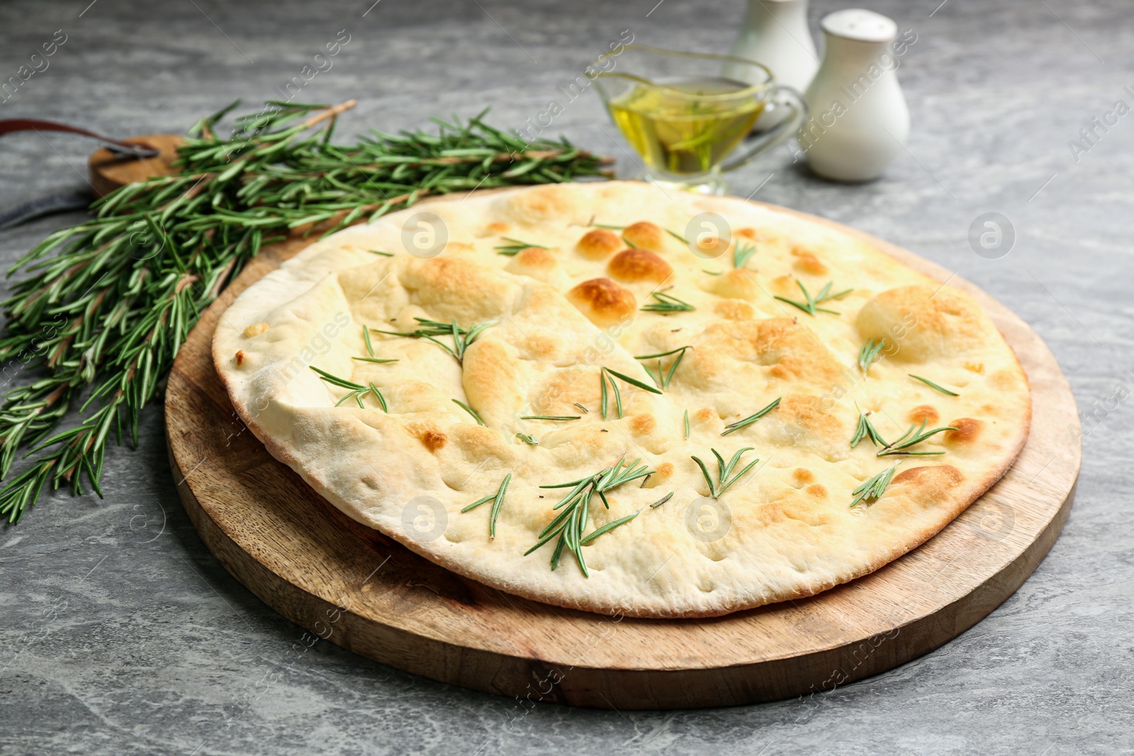 Photo of Delicious fresh focaccia bread on grey table