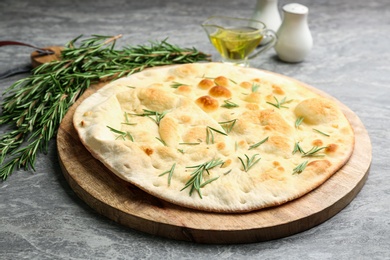 Photo of Delicious fresh focaccia bread on grey table