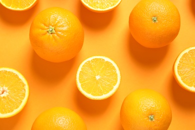 Flat lay composition with ripe oranges on color background