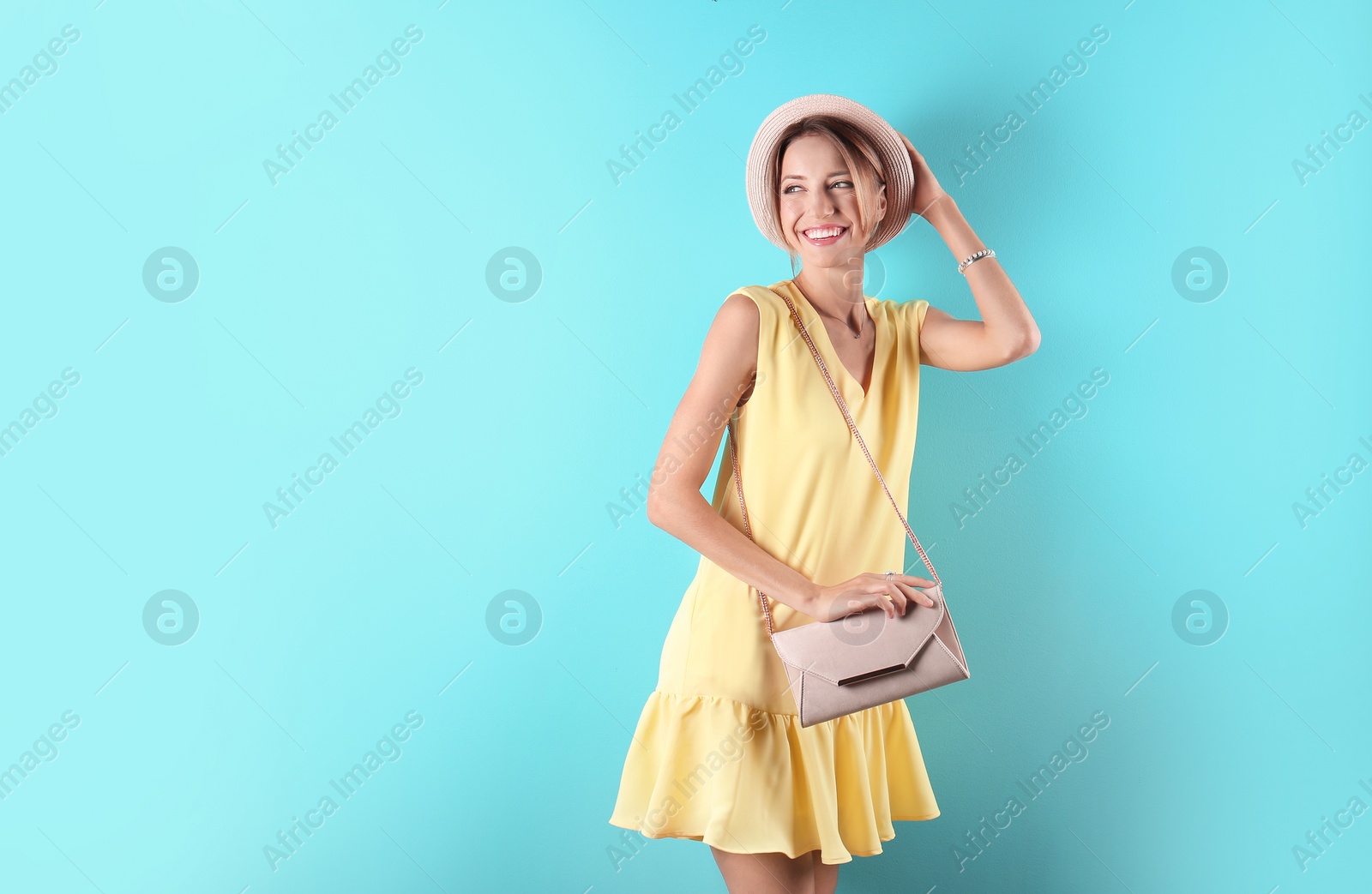 Photo of Portrait of young woman in stylish outfit with purse on color background