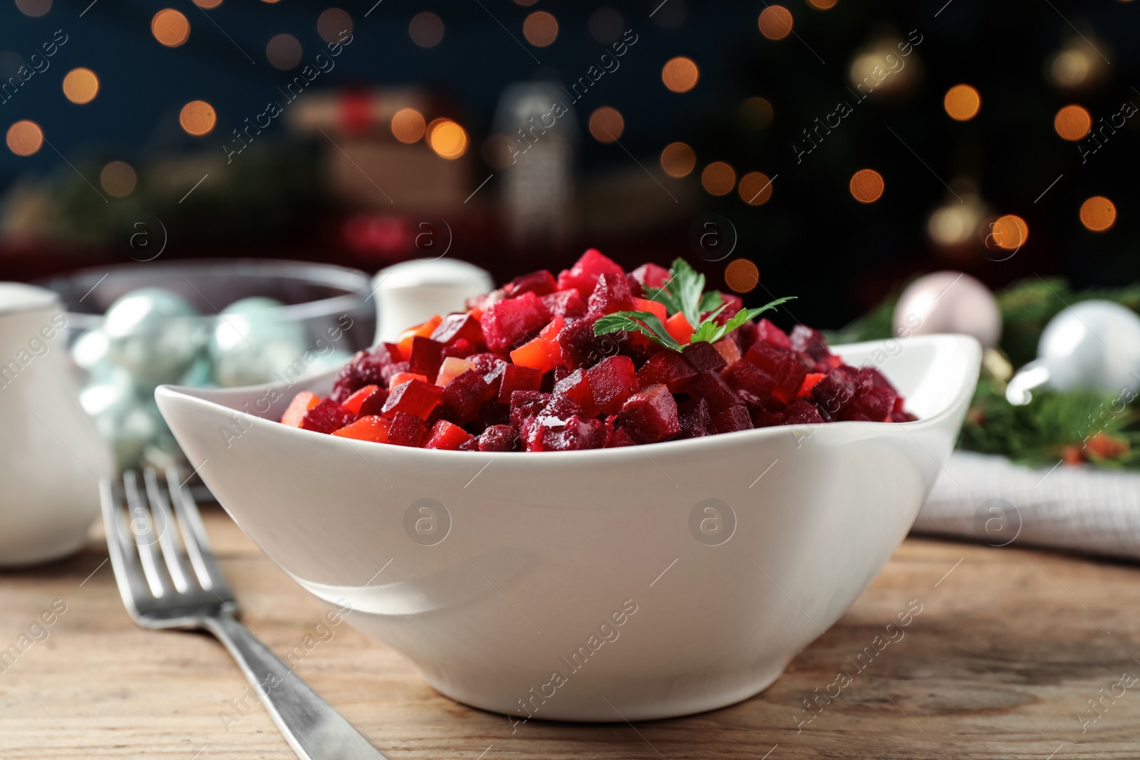 Photo of Traditional Russian salad vinaigrette served on wooden table