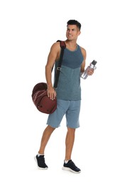 Photo of Handsome man with sports bag and bottle of water on white background