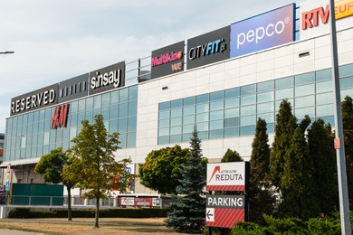 Photo of Warsaw, Poland - September 08, 2022: Shopping mall with many signs outdoors