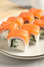 Tasty sushi rolls served on grey table, closeup