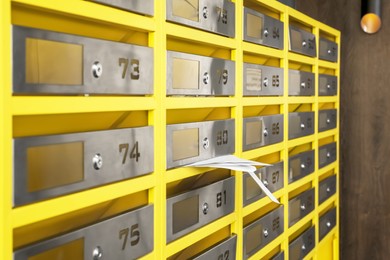 Photo of Metal mailboxes with receipts from post office indoors
