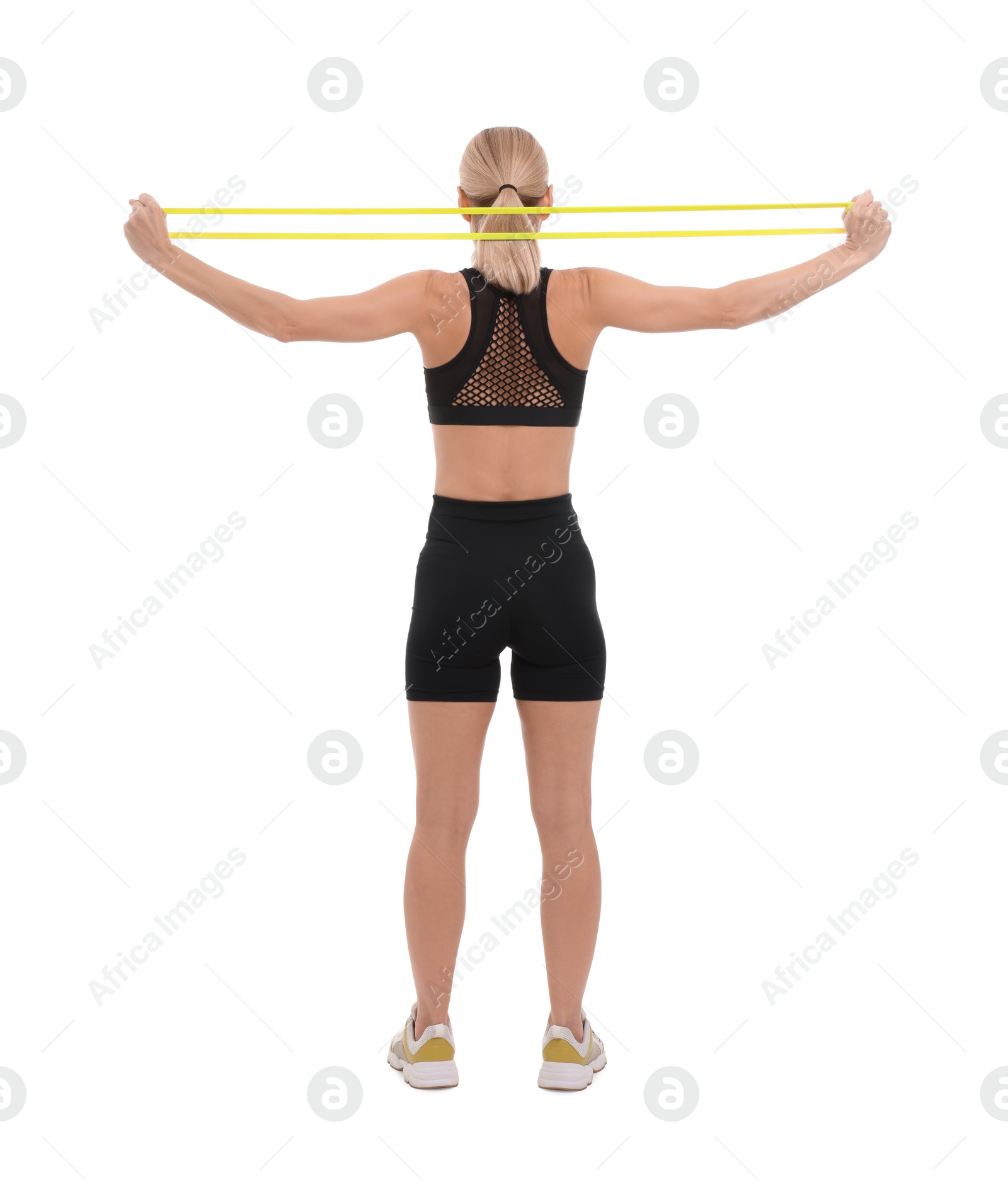 Photo of Woman exercising with elastic resistance band on white background, back view