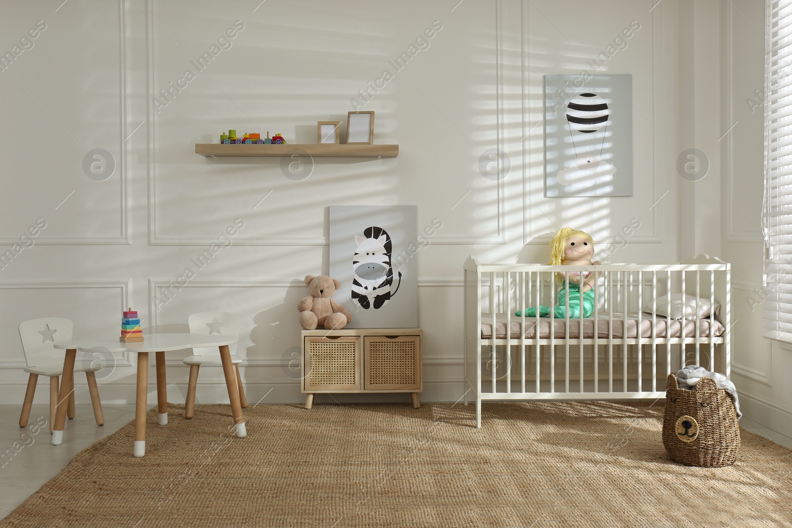 Photo of Light baby room interior with comfortable crib