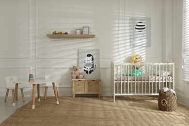 Photo of Light baby room interior with comfortable crib