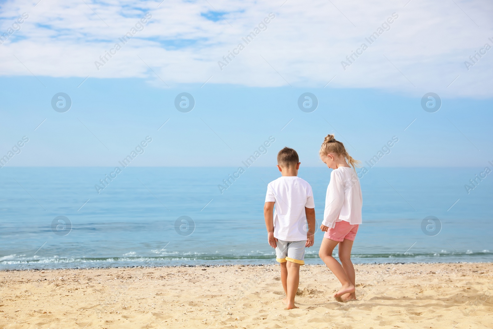 Photo of Cute little children on sea beach outside