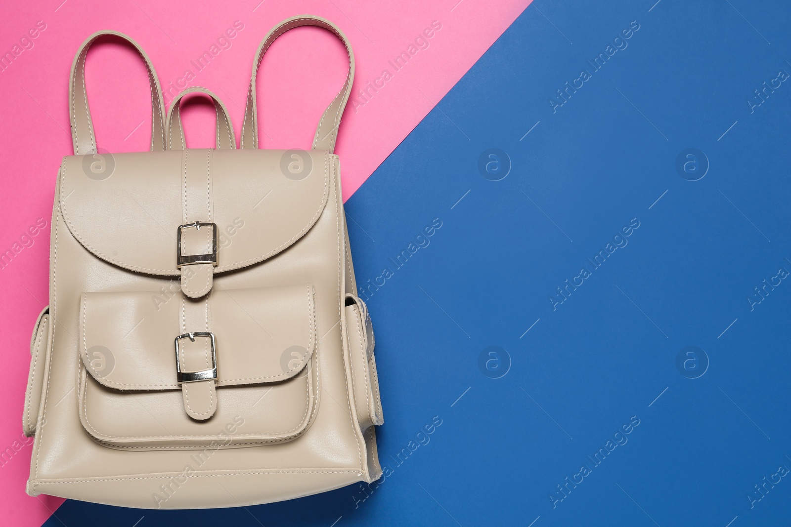 Photo of Stylish urban backpack on color background, top view. Space for text