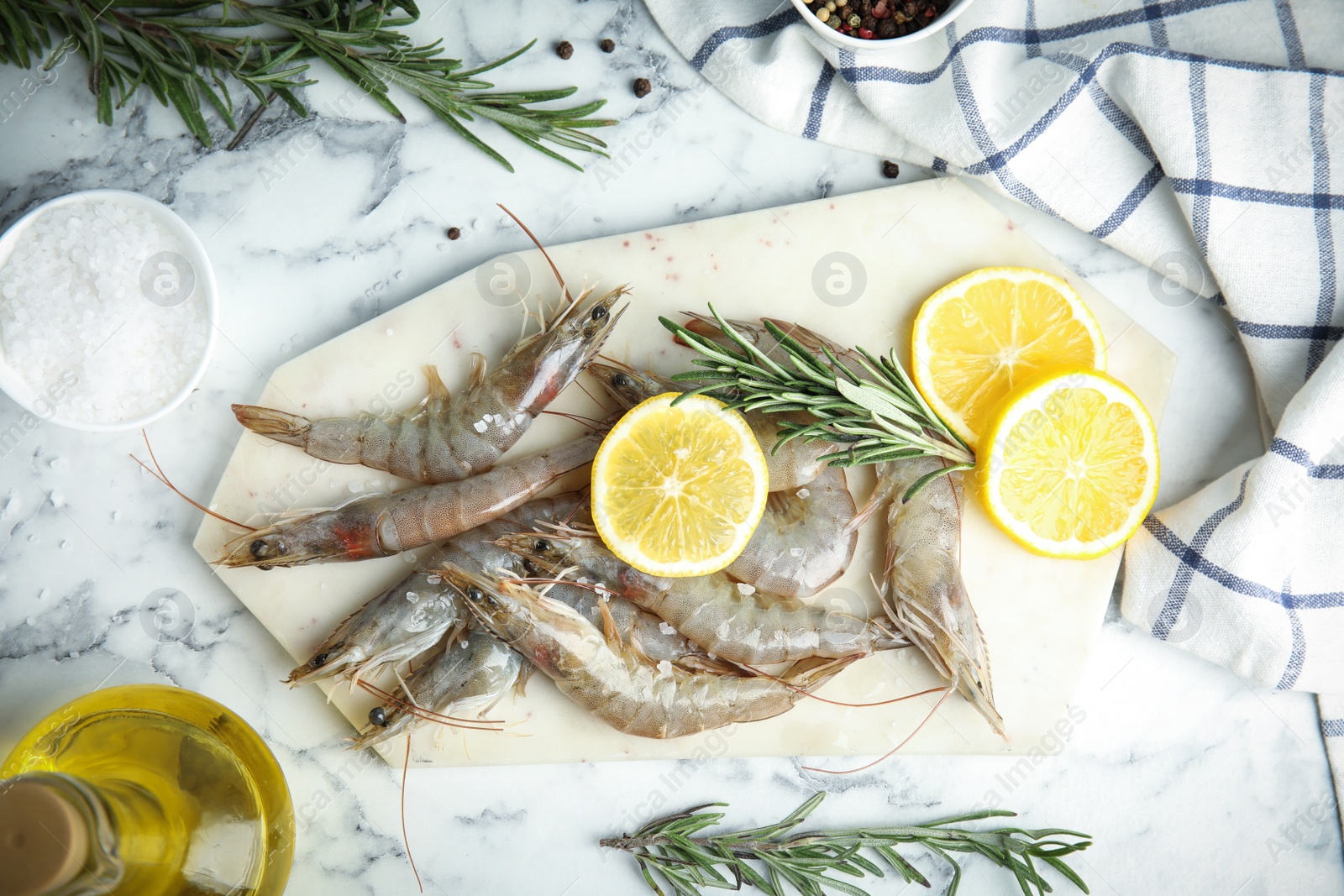 Photo of Flat lay composition with raw shrimps on marble table